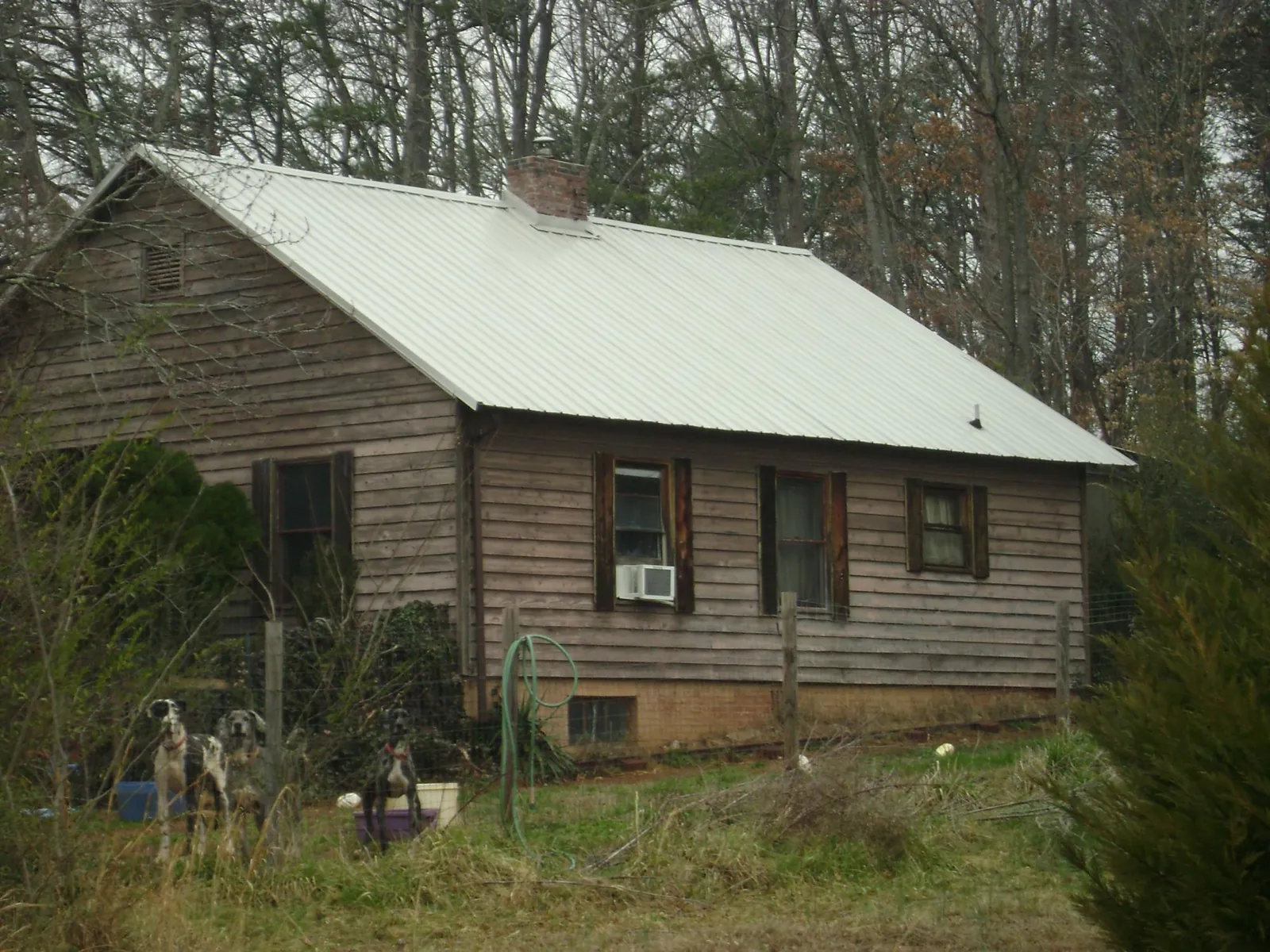 White metal roof on an old wood sided farmhouse, from a Asphalt Shingle Roof Repair job in Waterford
